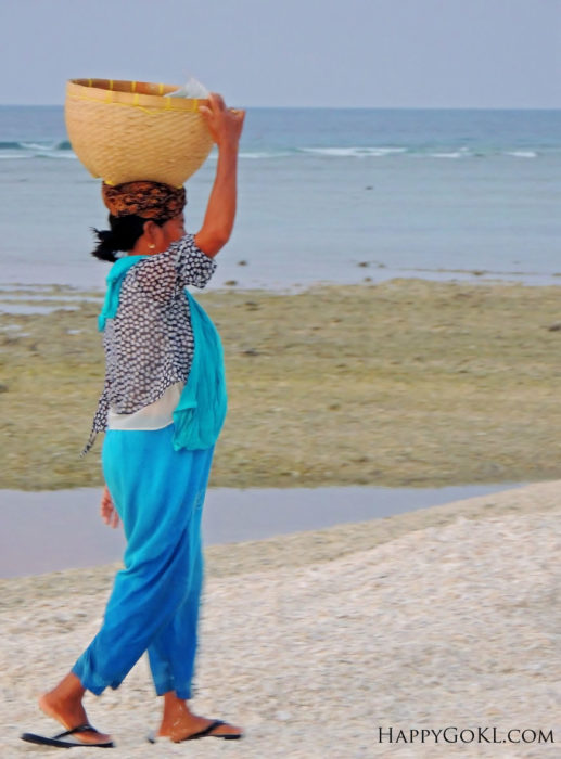 gili meno woman carrying a basket
